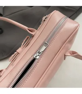 Close-up of smooth silver metal zipper and stitching on the pink bowling shoulder bag