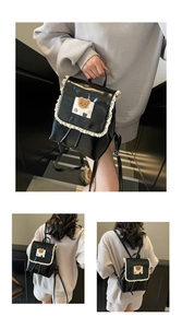 Detail of black PU leather backpack with lace trim and plush bear decoration