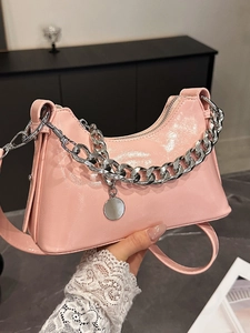 Pink patent leather underarm bag with silver chain strap and minimalist Y2K style