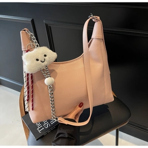 Pink lychee grain leather hobo bag featuring silver chain and plush cloud charm detail