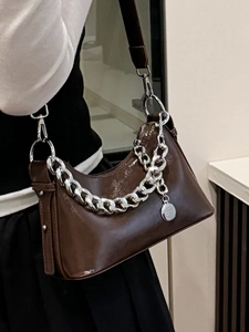 Deep brown oil wax leather shoulder bag with bold silver chain and adjustable strap