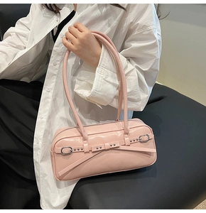 Detail of light pink bowling bag in glossy leather with silver buckles and studs