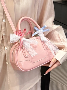 Pink glossy Boston handbag with lace bows and shoulder strap for a sweet Lolita style