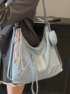 Light blue patent leather tote bag with round coin purse and woven rope detail