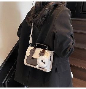 British vintage satchel in cream and coffee tones with a cute plush doll charm
