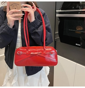 Detail of red bowling bag with elegant bow decoration and glossy leather texture