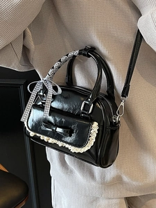 Chic black lace bowling bag with bow detail and ribbon-wrapped handles for women