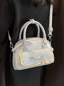 Light blue ballet core bowling bag with lace trim, bow detail, and ribbon handle for women