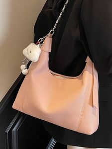 Nude pink lychee leather hobo bag with silver chain strap and plush cloud charm