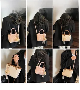 Detailed shots of stylish contrast color bucket bag worn as crossbody and handbag