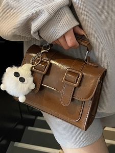 British style vintage brown Cambridge bag in glossy oil wax leather with plush charm