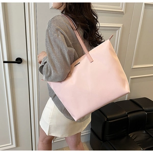 Detail view of pink nylon tote bag showing spacious capacity and smooth texture finish