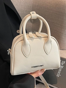 Minimalist beige lychee grain Boston bag with dual handles and metal logo detail