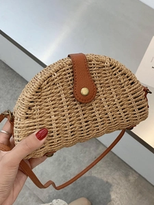 Handheld semi-circular straw crossbody bag with brown leather strap for summer vacation