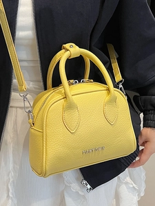 Elegant yellow lychee grain leather Boston bag with top handles and a crossbody strap