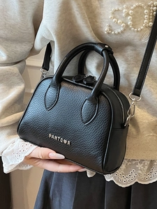 Elegant black lychee texture Boston handbag with silver metal logo and crossbody strap