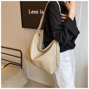 Detail of minimalist beige tote bag with soft lychee texture and adjustable shoulder strap