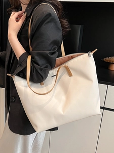 Large cream nylon tote bag with brown handles on model for professional daily commute