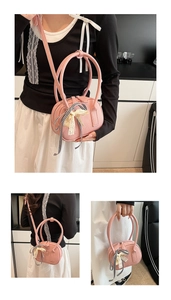 Detail of pink lychee leather bag featuring black gingham and beige lace bows decor