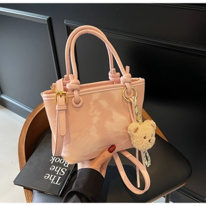 Pink marbled PU leather bucket bag with top handles and plush bear charm detail