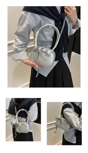 Detail of silver bowling bag with lace-wrapped handles and a stylish checkered bow