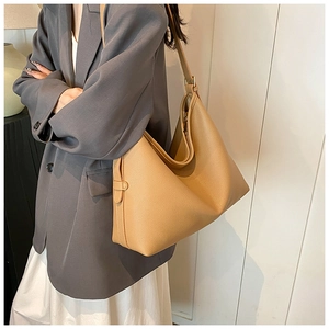 Detailed view of camel tote bag showing pebble leather texture and adjustable shoulder strap
