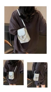 Close-up of light gray PU leather phone bag with woven texture and silver metal lock