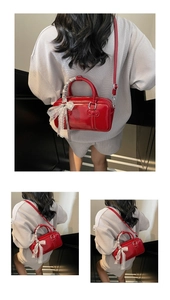 Detailed view of red glossy bowling bag with white lace bow and leather ribbon detail