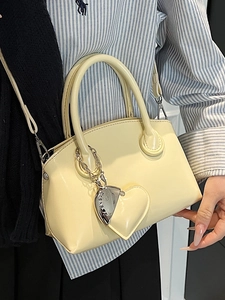 Minimalist cream yellow tote bag with heart charm and silver chain in shiny patent leather
