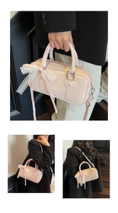 Detail view of light pink bowling bag with lace bow decoration and stylish shoulder strap