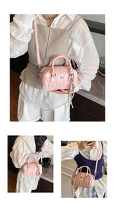 Detailed close-up of a pink quilted mini bowling bag with a stylish polka dot scarf