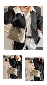 Detail view of metallic silver ballet bow shoulder bag with chain strap and ribbon decor