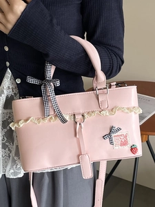 Pink minimalist crossbody bag with lace, strawberry pendant and bow decoration