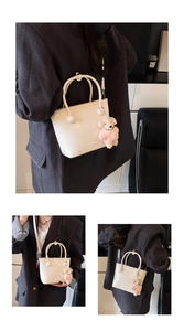 Minimalist beige bucket bag with round handle and cute teddy bear charm detail