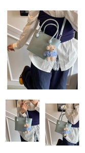 Detail of mint green PU leather bucket bag with brand embossing and blue bear charm