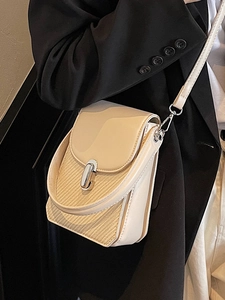 Chic beige crossbody bag with textured fabric panel and metallic twist lock detail