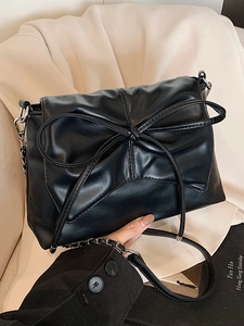 Elegant black ballet-style shoulder bag with large bow and silver chain strap