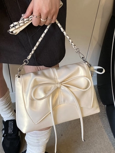 Elegant cream ballet-style pleated shoulder bag with pearl luster and bow detail