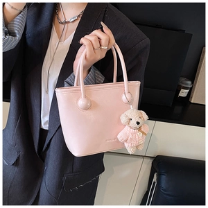 Pink leather bucket bag detail with CIAO&BHE embossed logo and cute teddy bear charm
