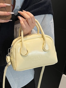 Cream yellow oil wax leather Boston handbag with detachable strap and embossed detail