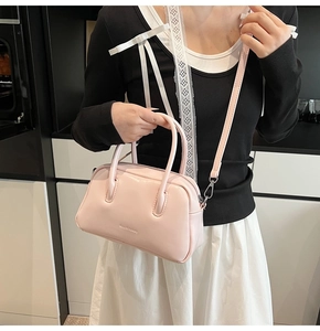 Detail of pink glossy faux leather Boston bag with Real & Luxury logo and top handles