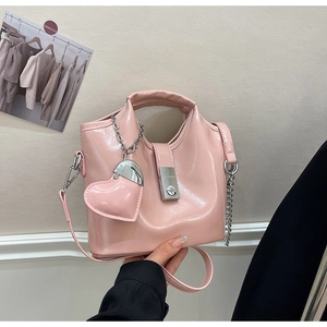 Détail du sac seau rose en cuir ciré avec fermoir argenté et breloque en forme de cœur