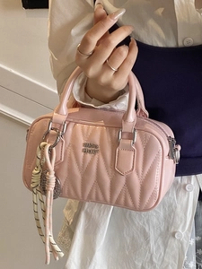 Pink quilted leather boston bag with metallic logo and decorative rope handle detail