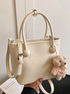 Minimalist cream white bucket handbag with adjustable strap and cute plush puppy charm