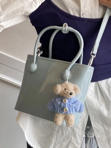 Light blue faux leather bucket bag with cute teddy bear charm and top handles