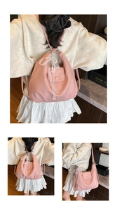 Detail of pink lychee pattern PU leather tote with lace bow and pearl pendant