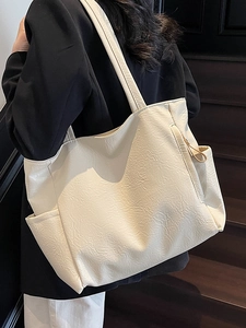 Minimalist cream white soft leather tote bag with pleated texture for urban commuters