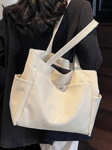 Minimalist cream white large leather tote bag with side pockets and long shoulder strap