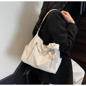 Vue détaillée du sac cabas blanc cassé avec fermeture éclair latérale et grigri nuage