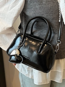 Glossy black Boston handbag with heart charm and silver metal hardware details